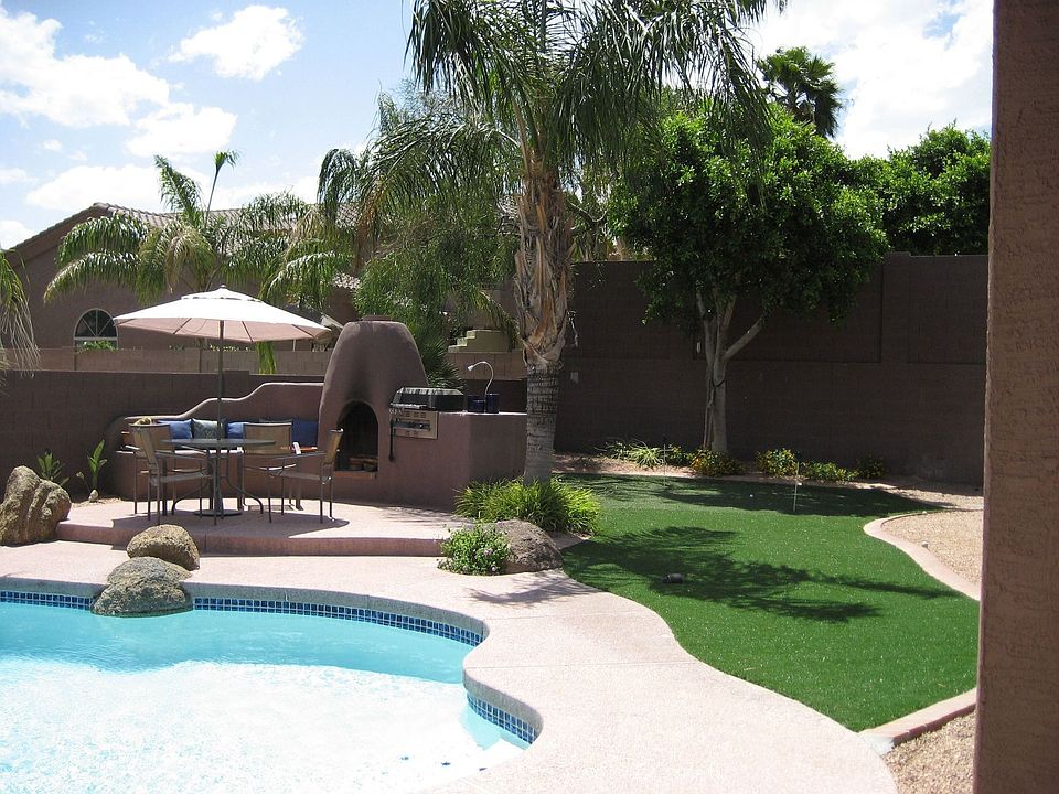 Putting green in resort-like backyard.