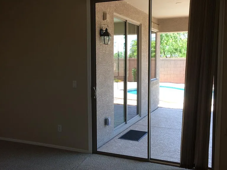 Primary bedroom sliding door to backyard patio