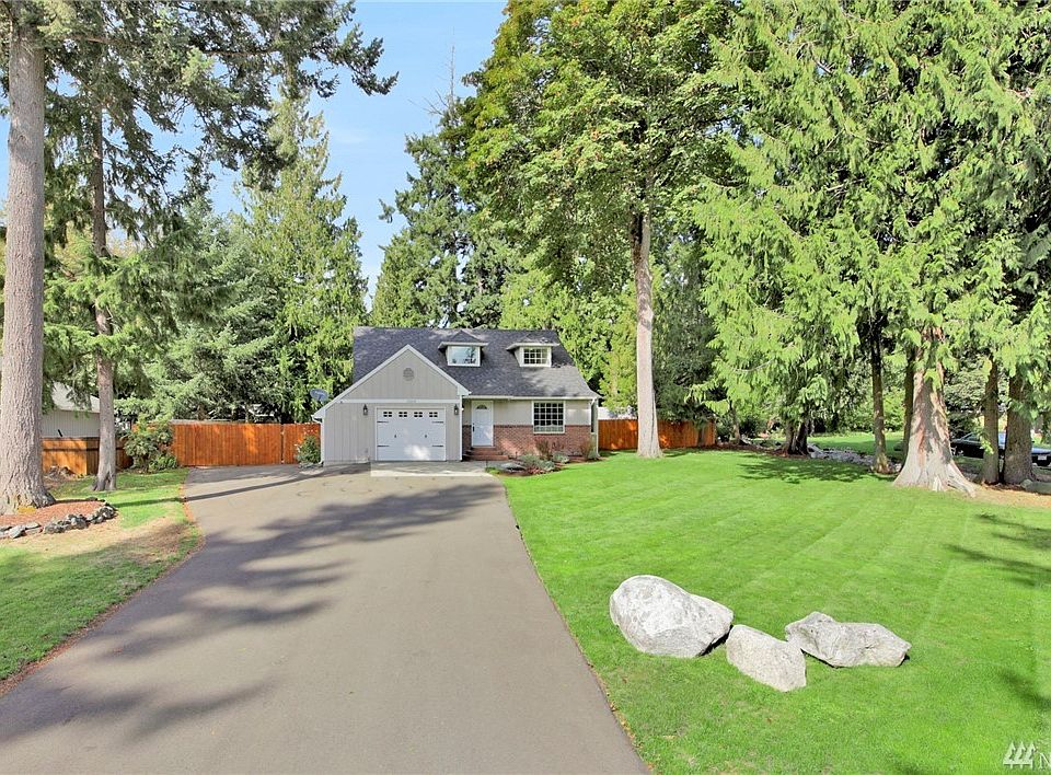 Freshly extended asphalt driveway adds to charm of this delightful cape cod style home at Lake Lawrence West.