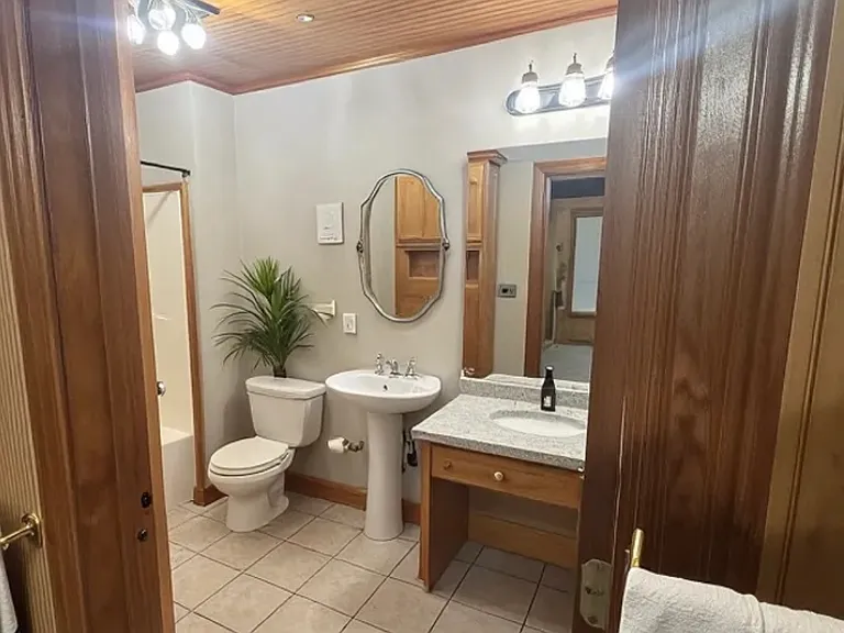 Bathroom with vanity and custom storage space and shelves.
