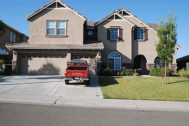 Front of home w/3 car drive through garage