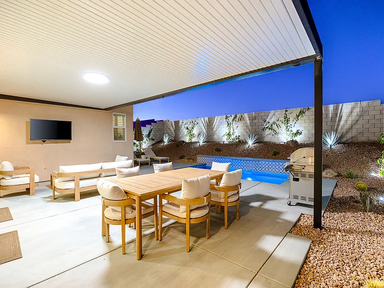 Dine outside under the stars with the pool glowing nearby.