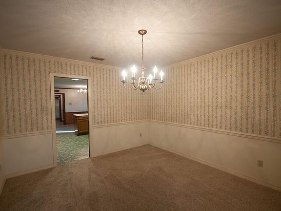 Spacious dining room with chair rail and moldings