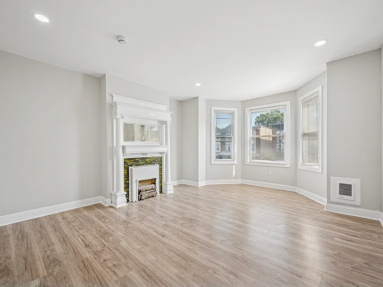Generously-sized living area with original accent fireplace and lots of sunlight