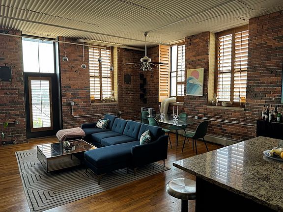 Open floor plan in corner unit with huge windows