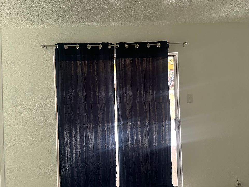 Slide door to backyard with curtains included