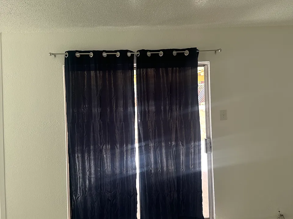 Slide door to backyard with curtains included