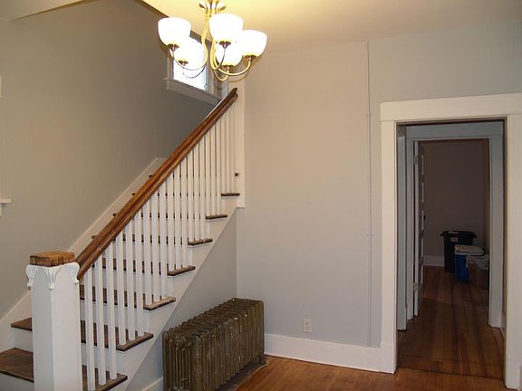 View of common entrance. Stairs are for upper unit. Door that is open in the photo leads to the main floor secure entrance.