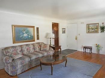 Adequate room in the living room with hardwood floor
