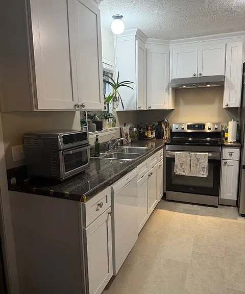 New kitchen and glass top range looking from table area