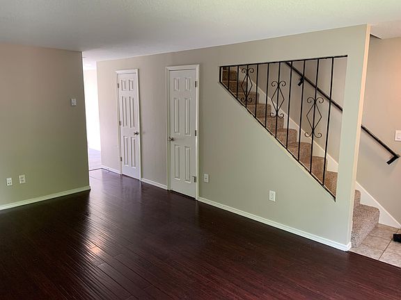 Living room facing kitchen. Closet with storage and guest bath doorways on the right.
