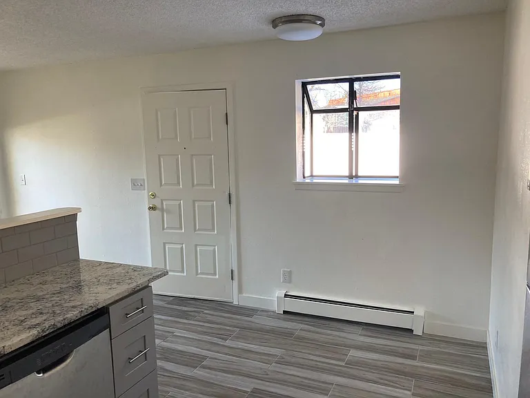 Standing at oven in kitchen and this is front door and eating area, spot for table and chairs.