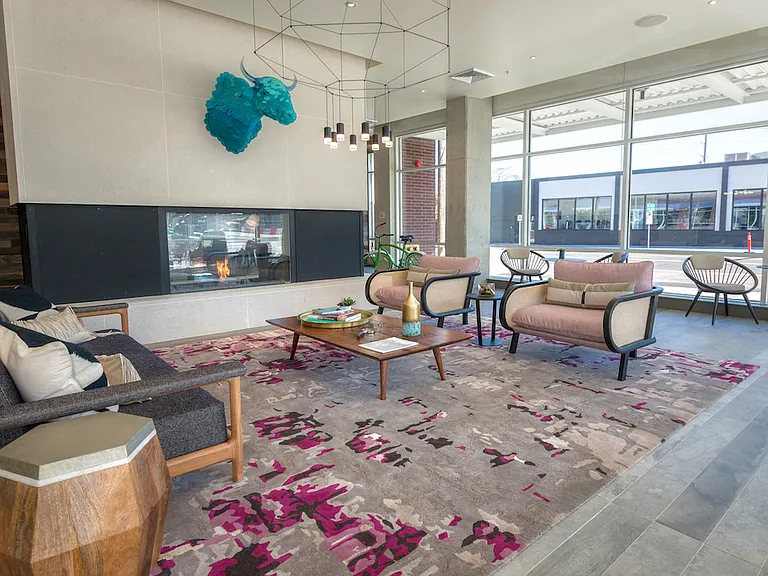 viting lounge with modern fireplace and comfortable seating.