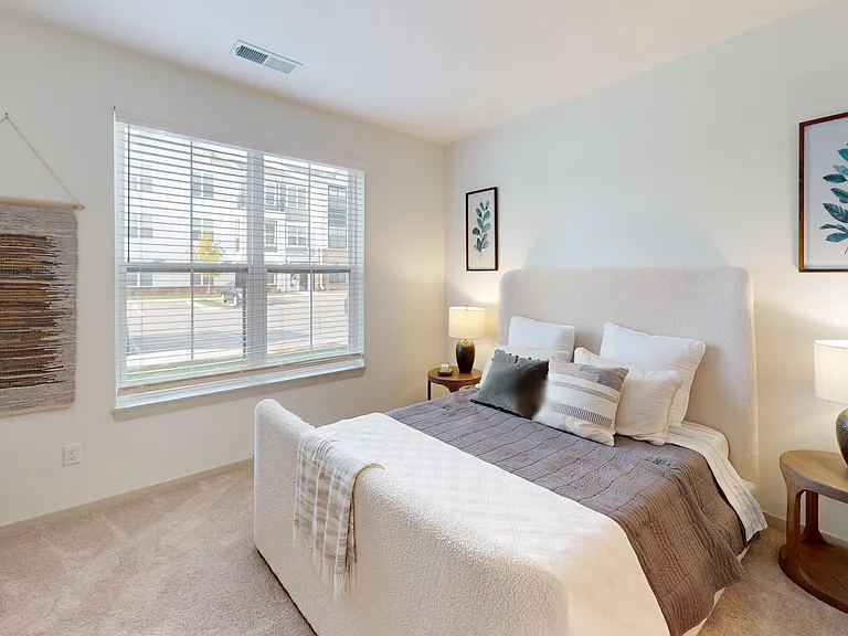 The Henry offers a spacious bedroom with plush carpeting and natural light. The Henry offers a spacious bedroom with plush carpeting and natural light.
