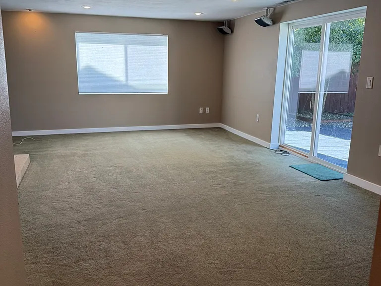 Downstairs family room, slider leads to lower patio or a door on the left (not shown in the photo) to the 2-car garage.