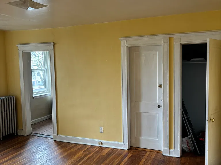 Living Room, left is kitchen room, mid EMERG exit door, right is closet door.
