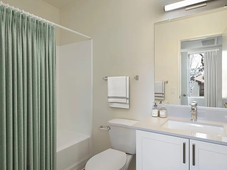Renovated Package I bath with light grey quartz countertops and new white cabinetry