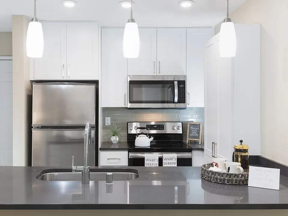 Modern Collection Kitchen With Quartz Countertops Ceramic Tile Backsplash And Stainless Appliances