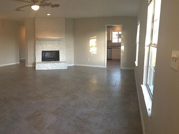 Nice tile and see through fireplace in living room.