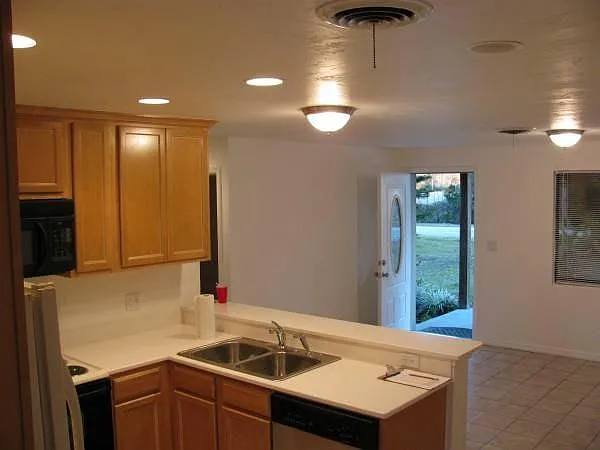Kitchen view into dining area and front porch. Appliances have been replaced since this picture