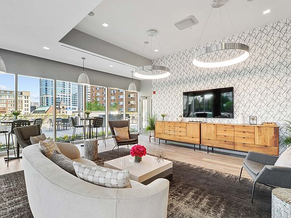 A modern living room with a large window overlooking the city.