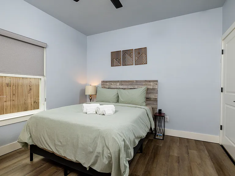 Primary bedroom with queen bed featuring a tv as well as an attached closet space.
