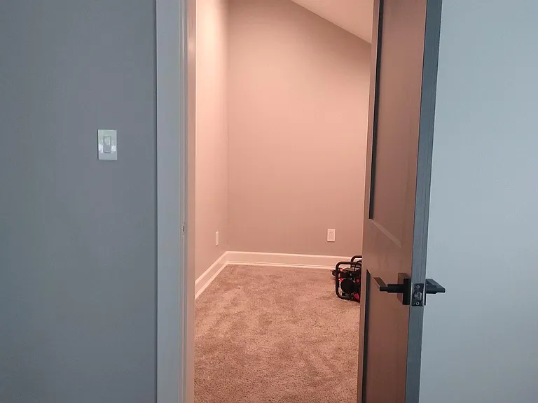 Upstairs bedroom #1 and huge closet (clothes poles and shoe tower being installed on far wall)