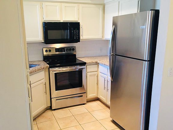 Updated kitchen with granite counters and stainless steel appliances