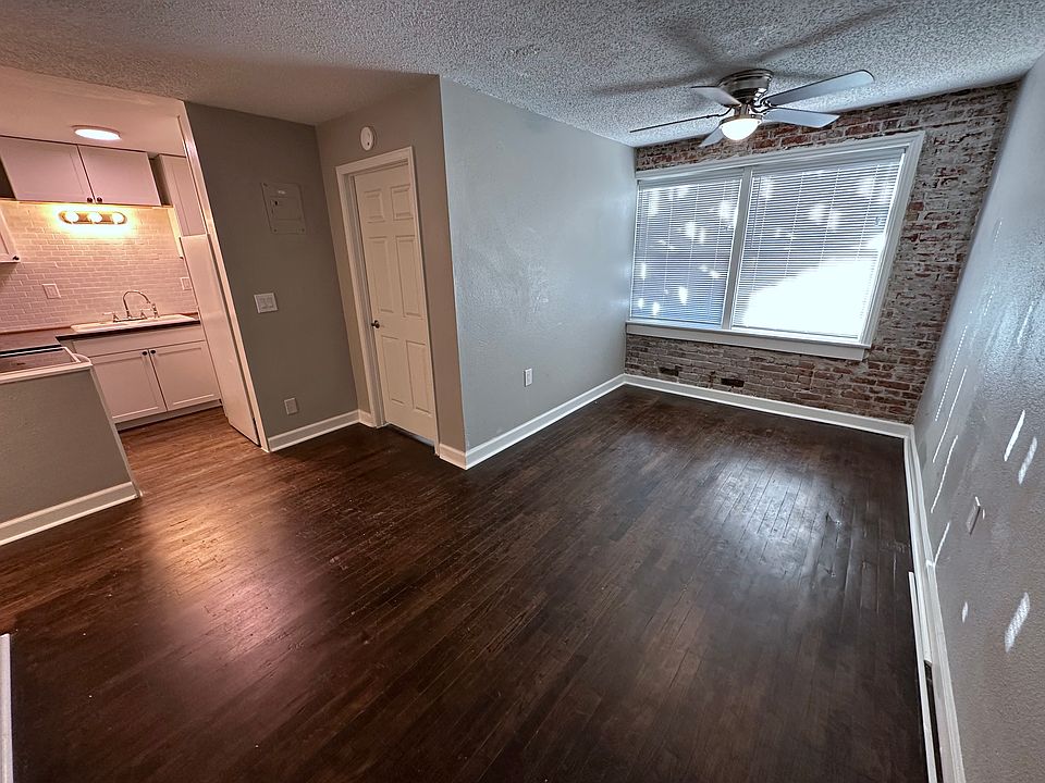 Living room - freshly painted walls, refinished original oak floors, and exposed brick.