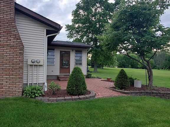 Private brick patio with very large, well cared for lawn