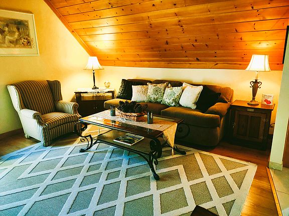 Guest House Living Room: Spacious & Cozy Living Room with Queen Size Pull Out Sofa, Queen Anne Chair, Large Screen TV & Enjoy the Morning Sunshine on Balcony with Table & Chairs