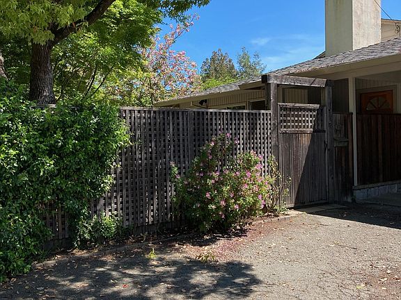 Entry to patio through gate. Carport to right.