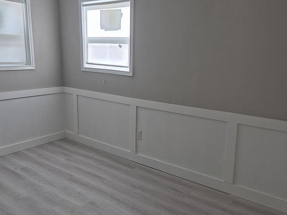 Second bedroom with 2 windows and loads of architectural details.