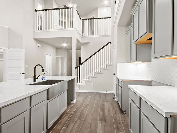 Two-story kitchen with abundant cabinet and counterspace