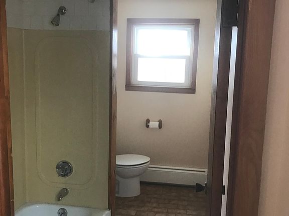 Bathroom with standup shower and bathtub, with curved shower rod to give you additional elbow room. Nice view out to the backyard from the window