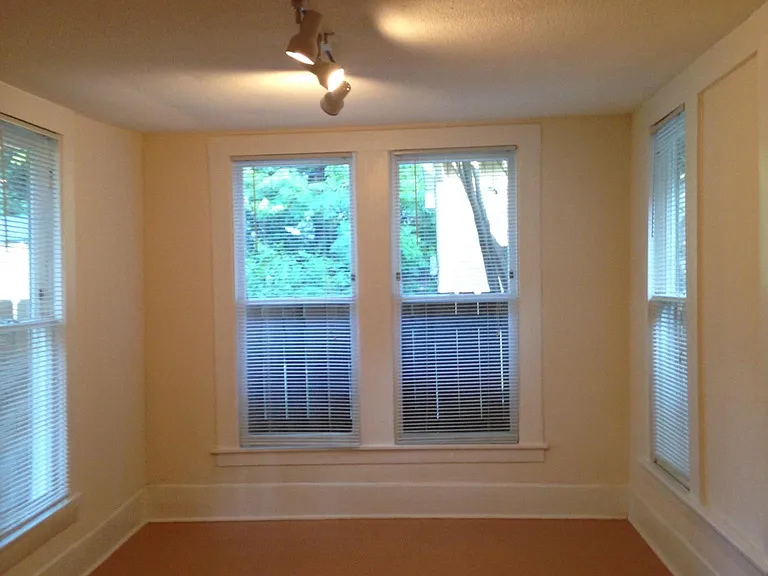 Large back bedroom with many windows and closet space.