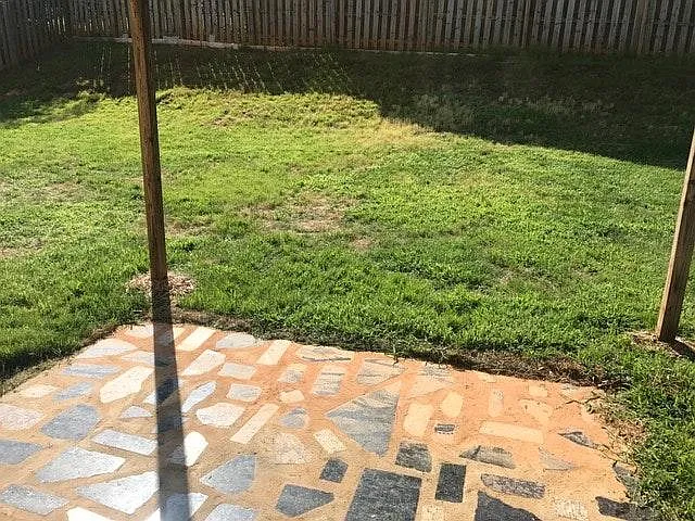 Shaded patio with fenced yard