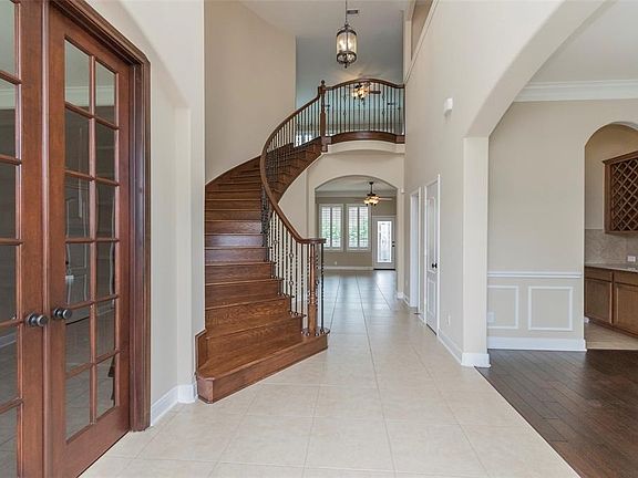 Dynamic Staircase With Metal Spindles & Stained Hand Rails To Match Wood Floors.