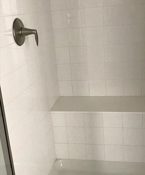 Master shower has a good sized bench in the shower. Tile goes up to the ceiling