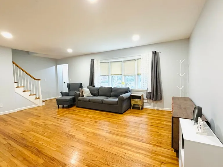 Sunlit filled living room with large bay window