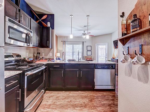 Kitchen with dark cabinets, and stainless steel appliances