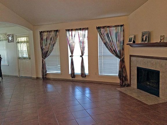 The huge living room is adorned with a wall of windows. Lots of natural light!