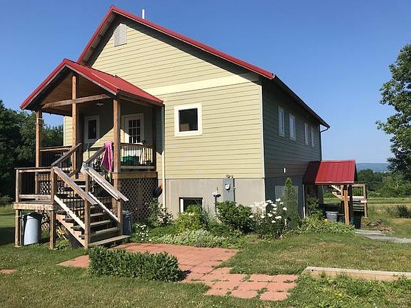 The approach to the upstairs apartment, from the parking lot, is through a cement tiled patio. Tenants are invited to store bikes and outdoor things under the front porch.