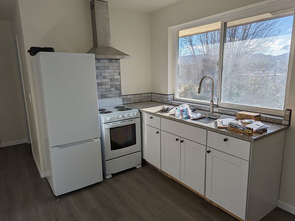 Modern kitchen with sleek cabinets & west-facing views of valley sunsets. Features a dedicated mini-split for AC/heat, laundry hookups, and a slider to your private deck. A bright, functional space designed for comfort and indoor-outdoor living.