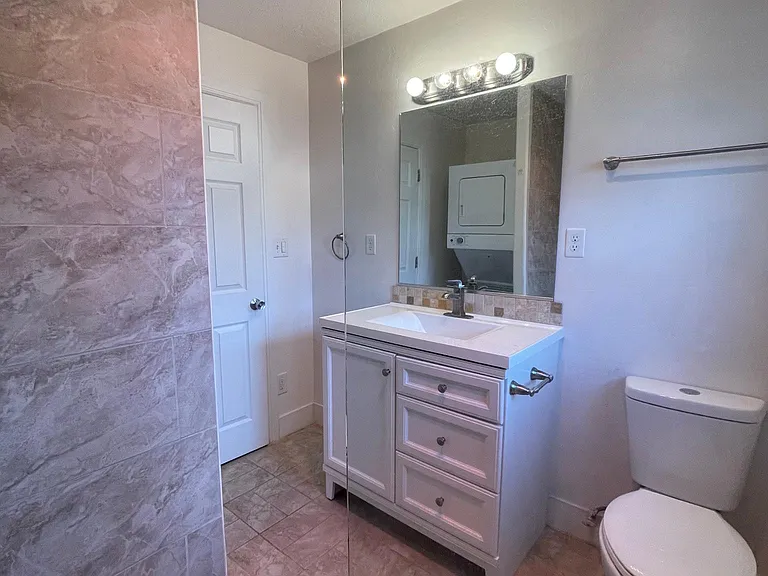 Bathroom upstairs with premium tile and fixtures and stone flooring for a spa feel