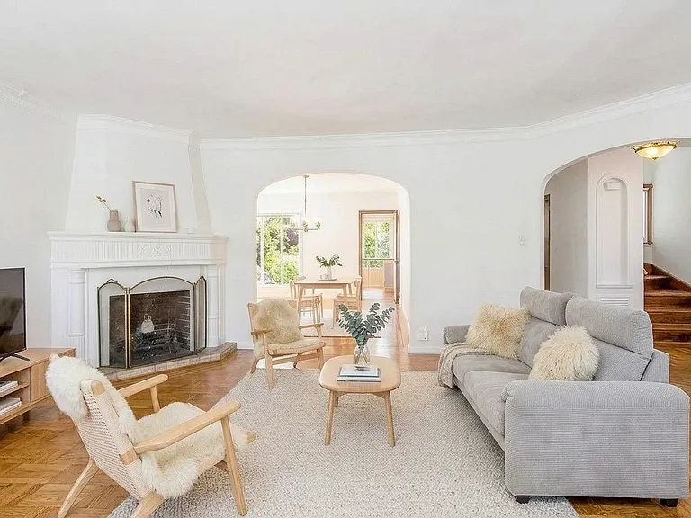 Living room on main level with open concept leading into the dining room, styled with ai.