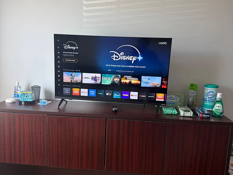 Common-area media setup with a large flat-screen TV and a long console offering ample storage for shared essentials.