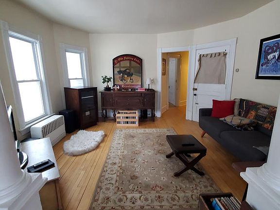Entry living room-taken from 2nd living room. Towards door to apartment and hallway beyond