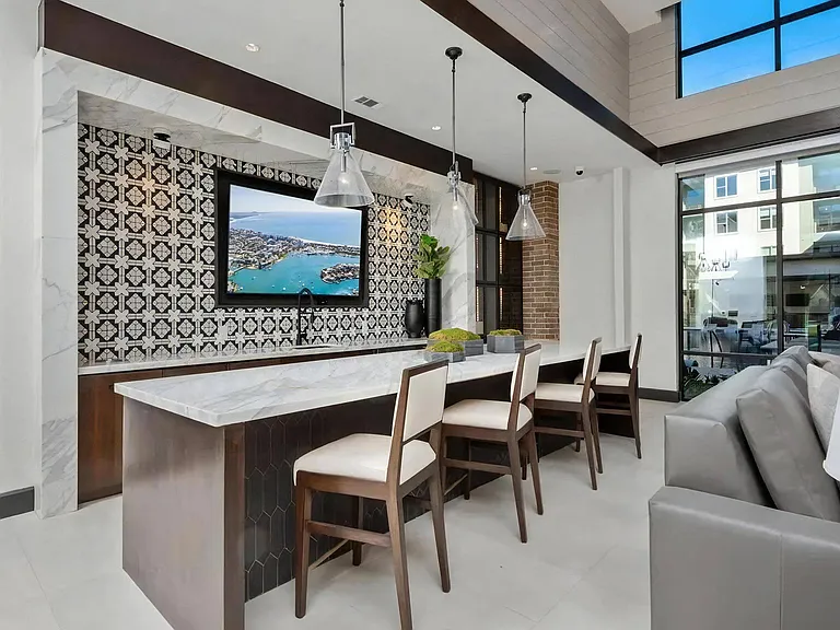 Community Bar with Marble Countertop and Wall-Mounted Screen
