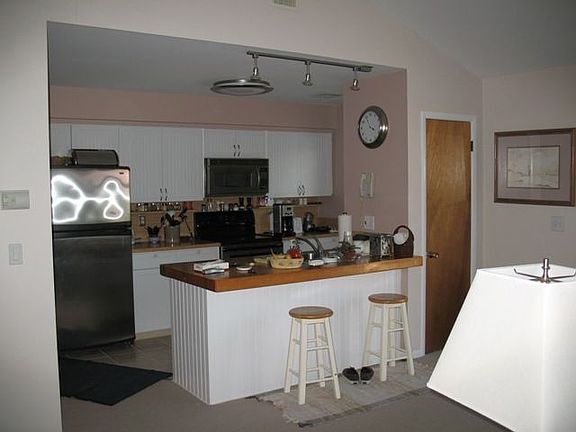 open kitchen with bar stools